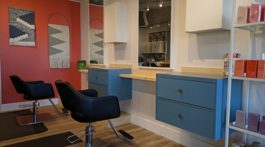 Blue styling stations with terracotta wall and woven art