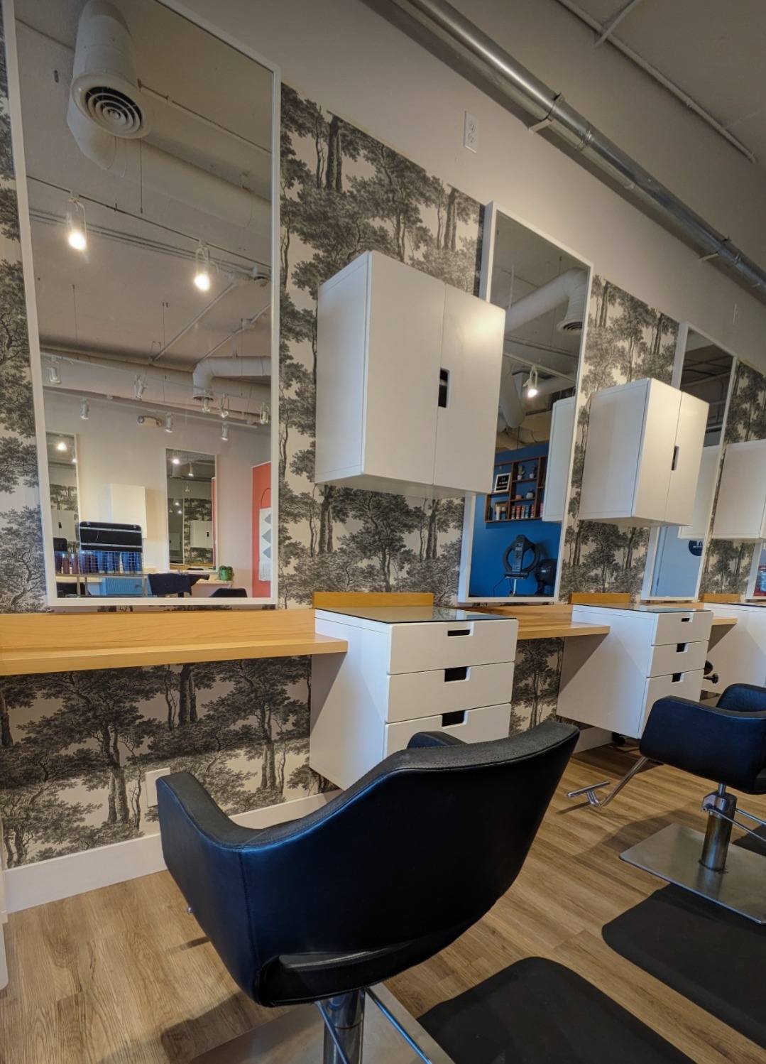 Styling stations with mirrors and forest wallpaper